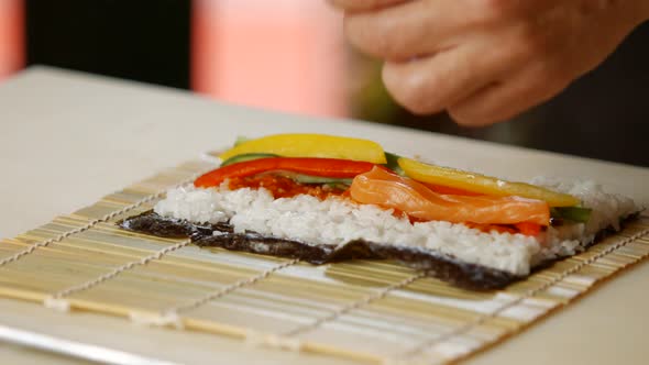 Man's Hands Making Sushi.