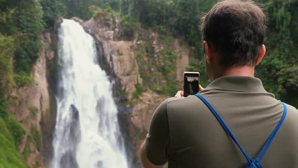 Blogger Man or Vlogger Recording Video of Beautiful Waterfall Video Shooting