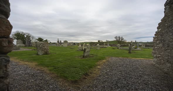 Motion time lapse of historical abbey and graveyard in rural Ireland during a cloudy day.