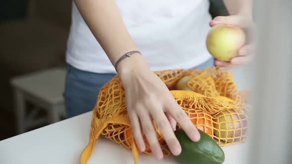 Reusable Minimalist Grocery Bag with Fruits and Vegetables on the Kitchen on White Table Iroi