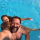 Happy caucasian people couple have fun and enjoy the swimming activity at the pool - VideoHive Item for Sale