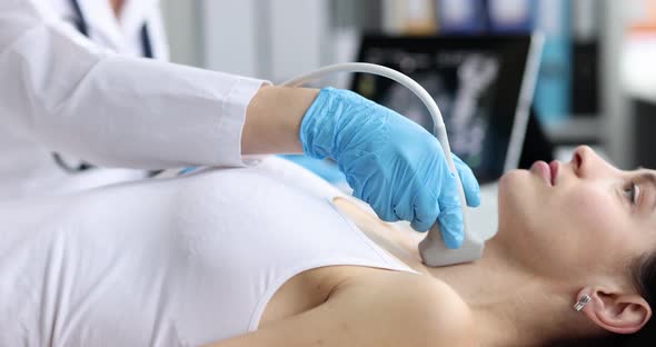 Doctor in Diagnostic Center Makes Ultrasound of Thyroid Gland