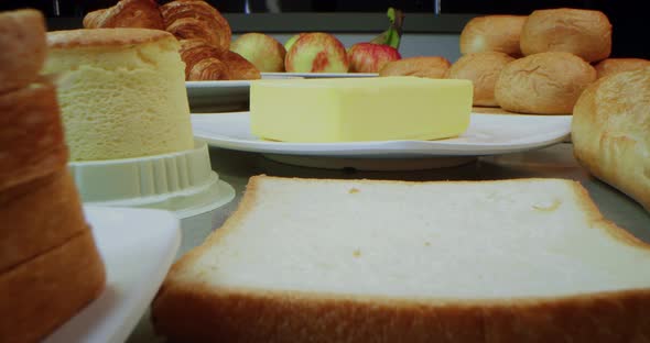 On the Table Breakfast Items Buns Apples Butter Garlic Kurosan Egg Cake Butter and Jam a Sandwich