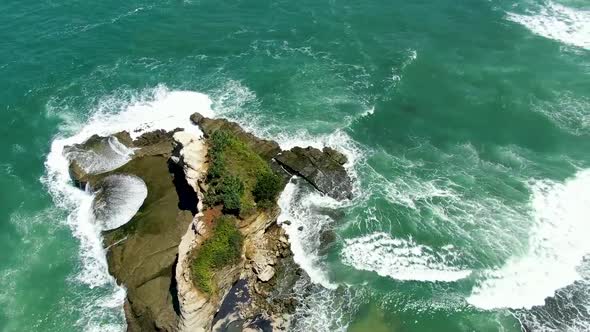 Scenic rock at popular Klayar beach in East Java, Indonesia, aerial reveal shot