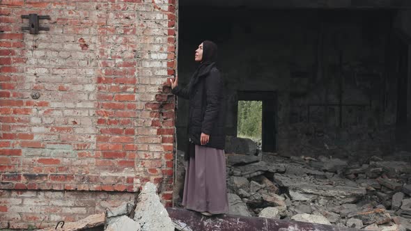 Woman in Hijab Standing in Demolished House