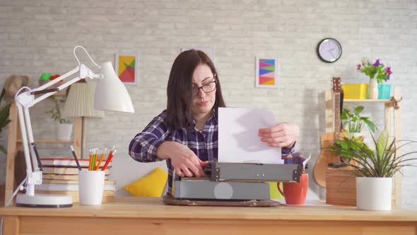 Young Woman Writes Without Inspiration on a Typewriter and Throwing the Paper