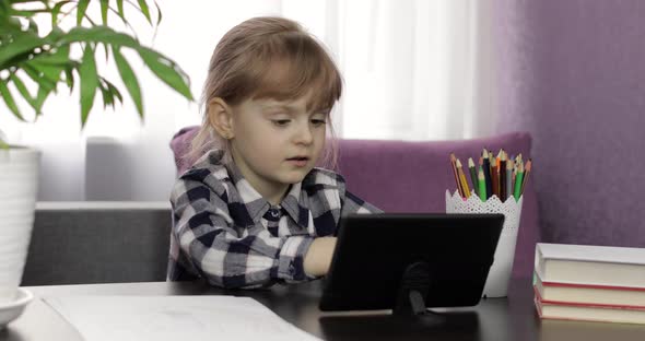 Girl Doing Online Homework Using Digital Tablet Computer. Distance Education