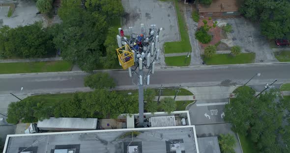 4K Aerial video of tower workers on cellular tower