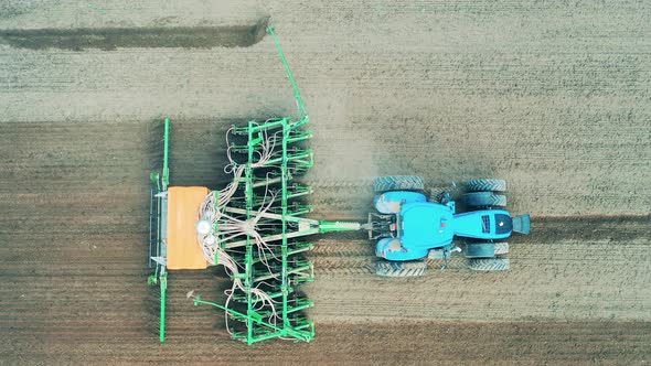 Agricultural Planting of a Field Held By a Tractor in a Top View