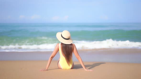 Asian woman enjoy around beautiful beach sea ocean