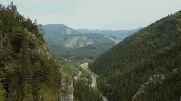 Aerial View of a Mountain Road in a Beautiful Deep Gorge. Cars Move on a Mountain Road.