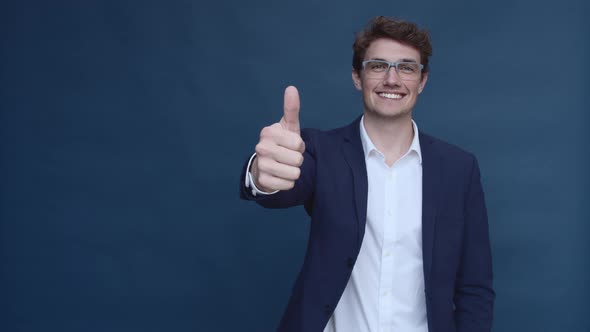 Handsome Caucasian Man with Glasses Giving a Thumbs Up