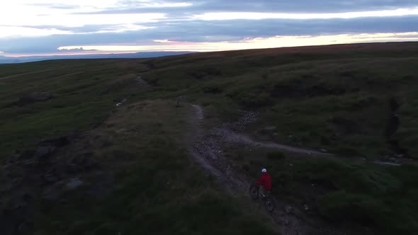 Aerial shot of a mountain biker on a singletrack trail.