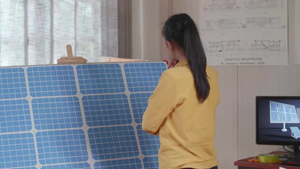 Woman Walks Into The Office To Look At The Solar Cell