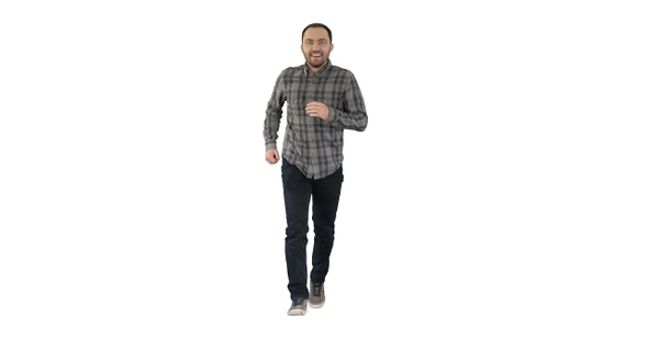 Young man running excited on white background.