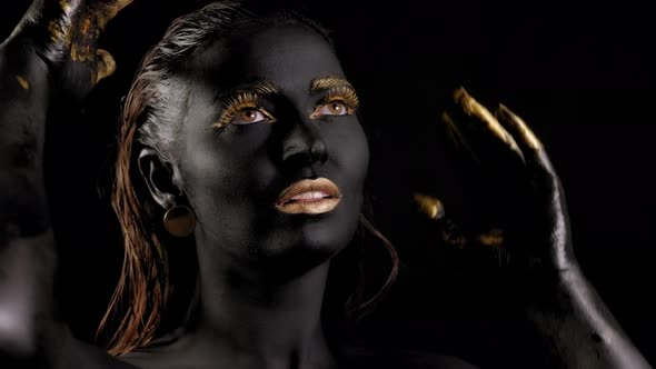 Portrait of a Young Woman with Magical Black Skin and Golden Hands