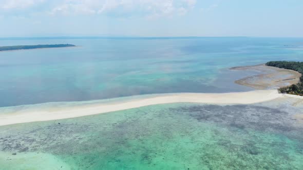 Aerial: tropical beach island reef caribbean sea white sand bar Snake Island, Indonesia Maluku