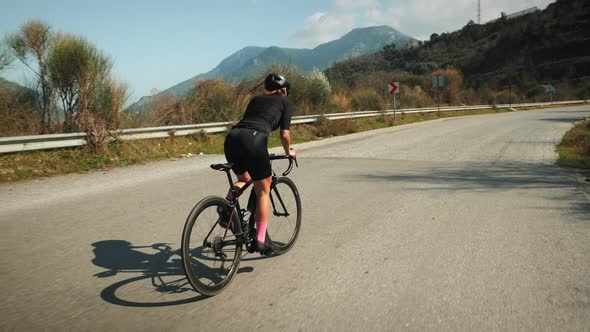 Professional road cyclist training on bicycle.