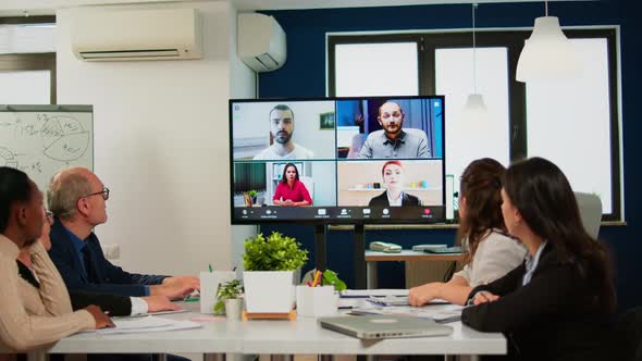 Headshot Screen Application View of Remote Multiracial Employees Talking on Video Call