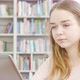 Lovely Teen Girl Using Laptop at the Library - VideoHive Item for Sale