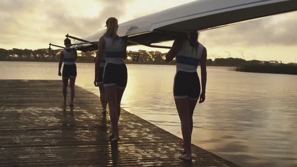 Female rowing team training on a river