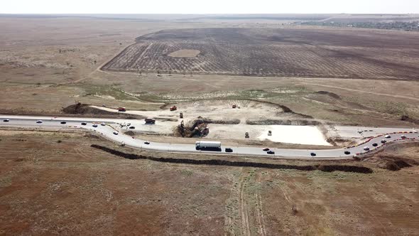 Aerial Road Constructions, Machinery and Mine Equipment Near Road on Sandy Surface