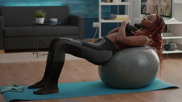 Slim Black Woman Practicing Morning Workout in Living Room