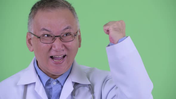 Face of Happy Mature Japanese Man Doctor Getting Good News