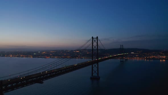 Aerial View of Car Traffic Across the Sea Over Ponte 25 De Abril Red Bridge in Lisbon Portugal