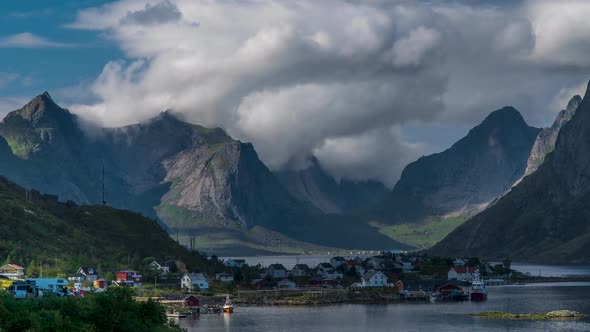 The Movement of Clouds Over Beautiful Mountain Peaks and a Small Fishing Village in Norway