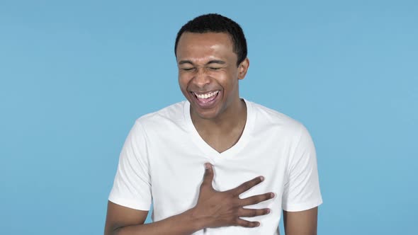 Funny Laughing Young African Man Blue Background