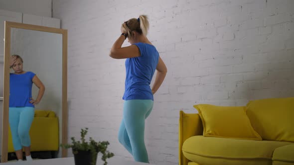 Woman Looking at Mirror Ashamed of Excess Weight