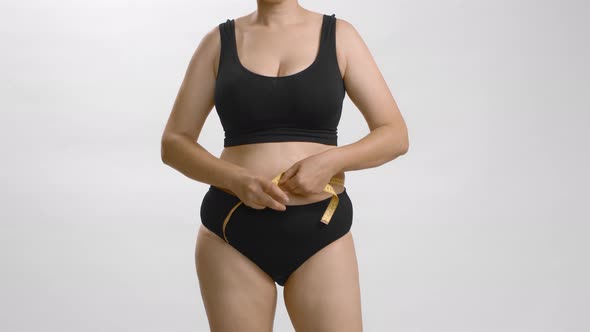 Excess Weight Caucasian Woman with Wrap Measure Tape Around Her Waist