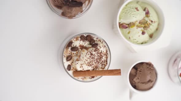 Vertical video: Set of different flavors of ice cream in glasses