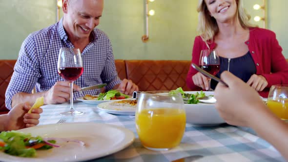 Family having meal together in restaurant 4k