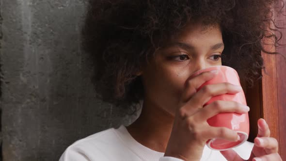 Front view mixed race woman drinking coffee