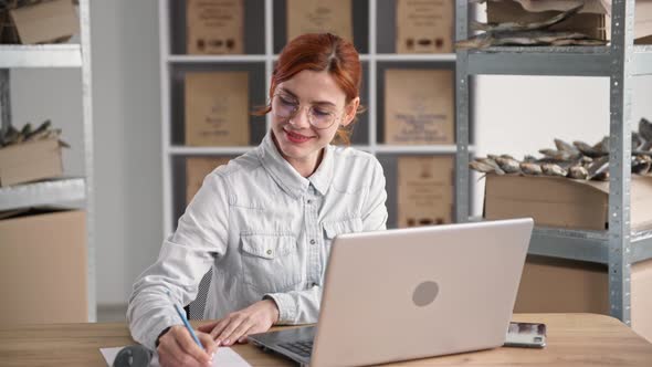 Young Businesswoman Small Business Owner Works Online and Takes Orders in Internet Shop While