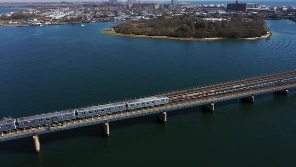 An aerial shot over Grassy Bay in Queens, NY. The camera dolly in & pan right following an elevated