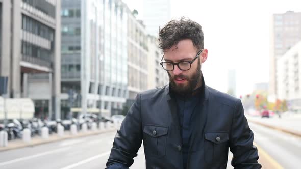 Slow motion portrait young smart casual bearded man outdoor