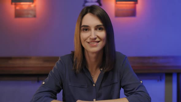 Portrait of Happy Woman in Shirt Sitting on Bar Counter Waiting for Friends