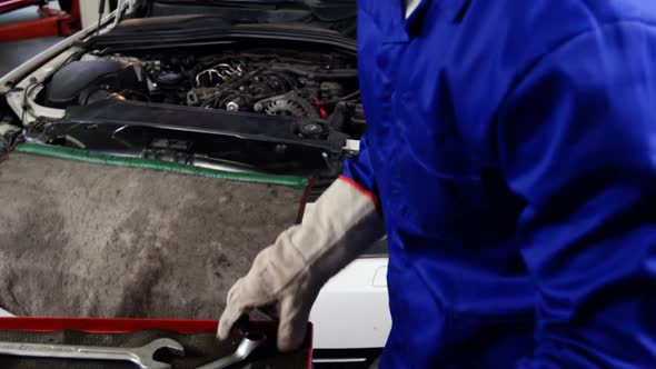 Mechanic servicing a car engine