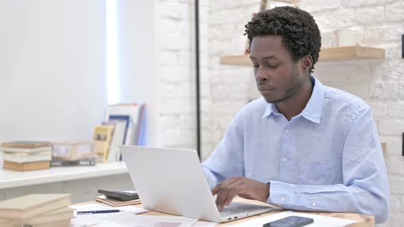 African Man Working on Laptop