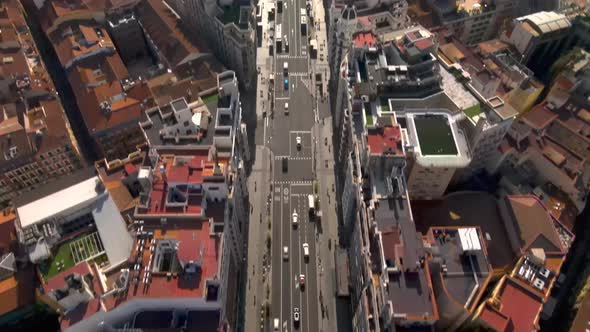 Top down view of busy street in Madrid tilts up to reveal city