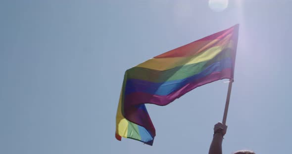 Pride LGBT rainbow flag waving in slow motion during a pride parade