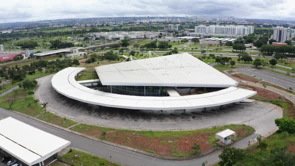 Empty bus terminal in Brasilia during COVID-19 pandemic. Tilt up, downtown in the background