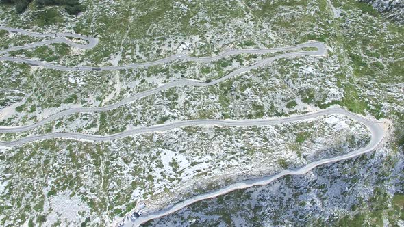 Aerial view of asphalt road curving on a hill