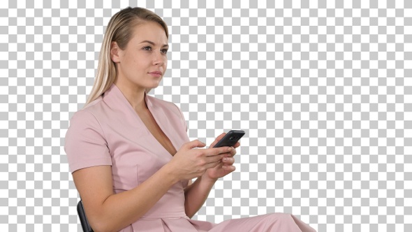 Smiling blonde woman sitting and using smartphone, Alpha Channel