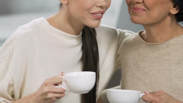 Adult Sisters Smiling and Talking with Tea Cups, Home Relax Atmosphere, Support