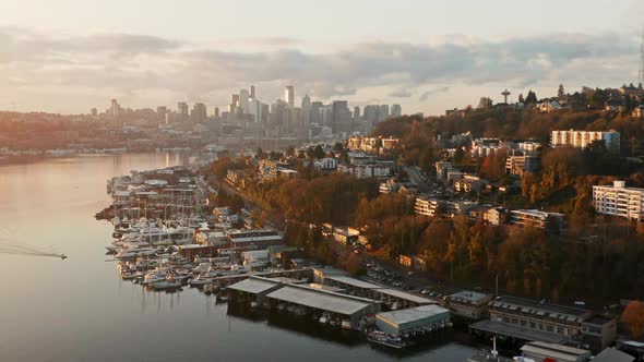 Drone Aerial Rise on Lake Union with Seattle Skyline in background and morning traffic. During sunri