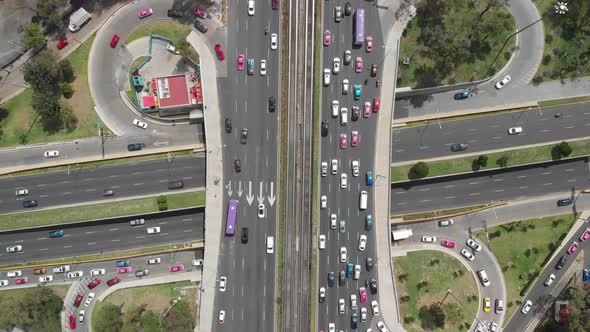 Aerial top view of traffic jam over a road junction. Drone slowly ascending